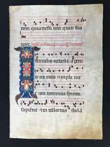 Ornamental Initial "I":  Individual sheet from a liturgical manuscript - antiphonary - on parchment.  Bologna, 1320-40  Writing in red and sepia brown / black  Music notation in brown / black sepia  Leaf of a large choir book with a magnificent "I"-initialmarking the beginning of the Introitus of St. John Apostle. The ornate, tall initial "I" sits on a blue field with white tracery.