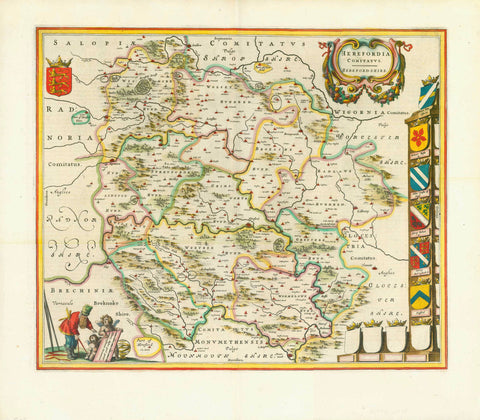 "Herfordia Comitatus, Herford-Shire". Copper etching by Wilhelm Janszoon Blaeu. Published in Amsterdam, 1645. Hand coloring.,  A single coat-of-arms decorates the upper left corner. In the lower left two cherubs hold the map legend for an onlooker. Verso: Text in Spanish about Herfordshire.